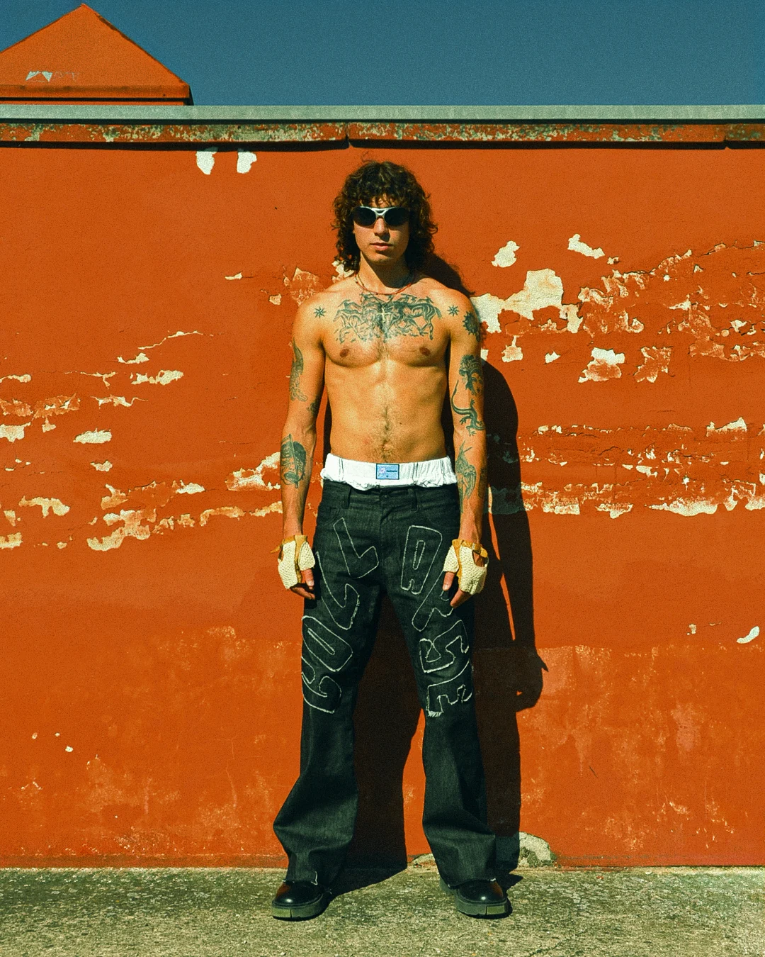 Full COLLAPSE denim look against the orange wall