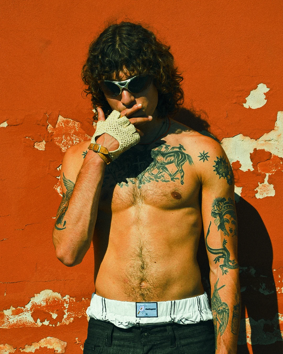Portrait of the model wearing sunglasses and a glove