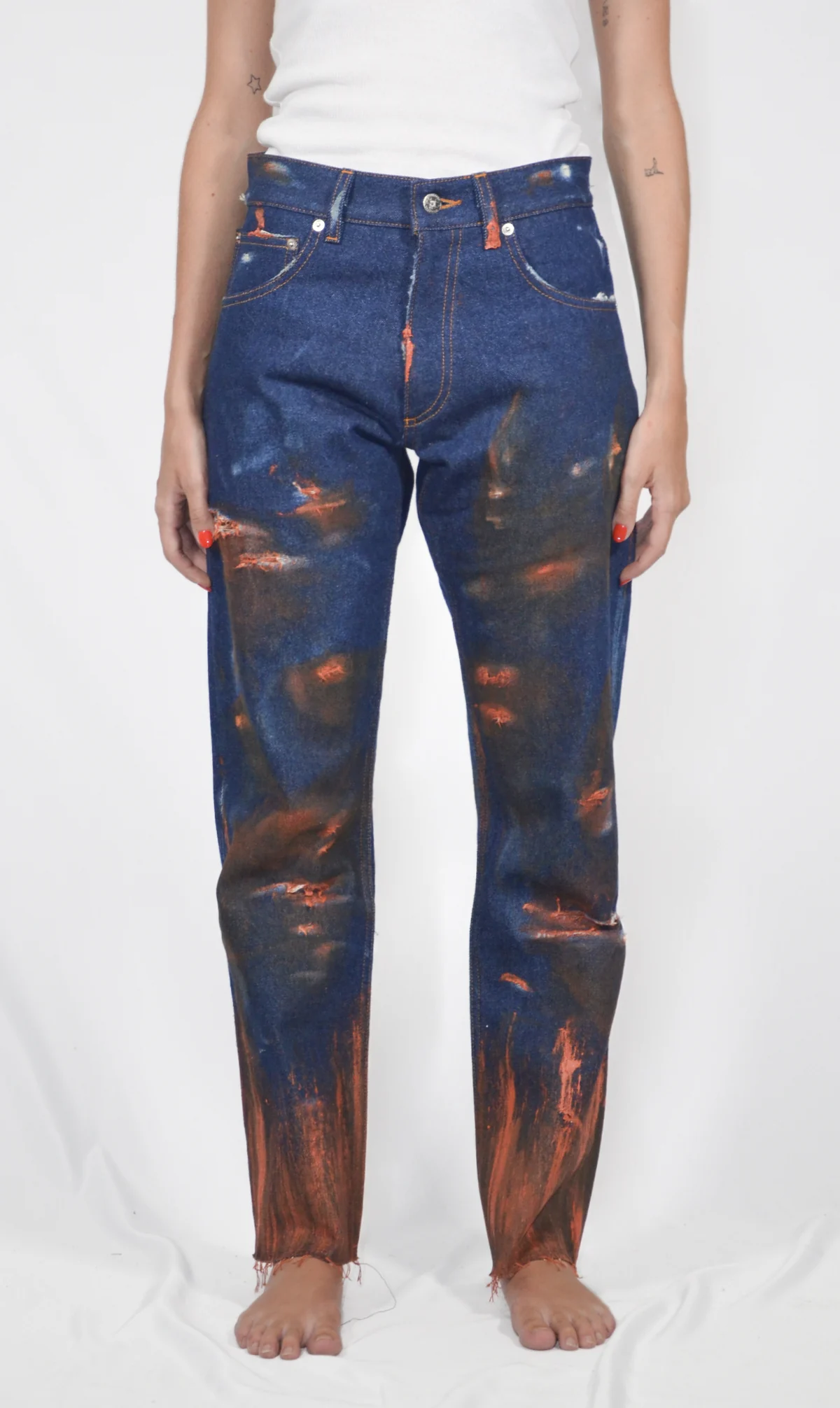 Front view of Fe26 jeans with rust-coloured treatments