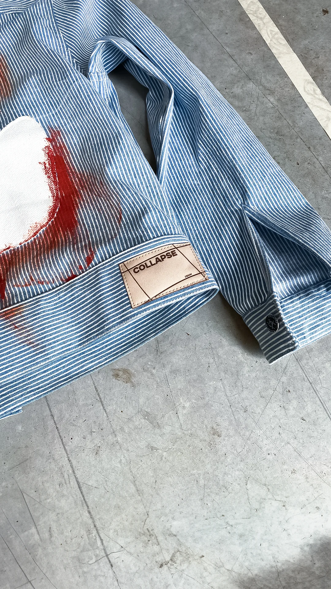 Detail of the Fe26 striped jacket with COLLAPSE label