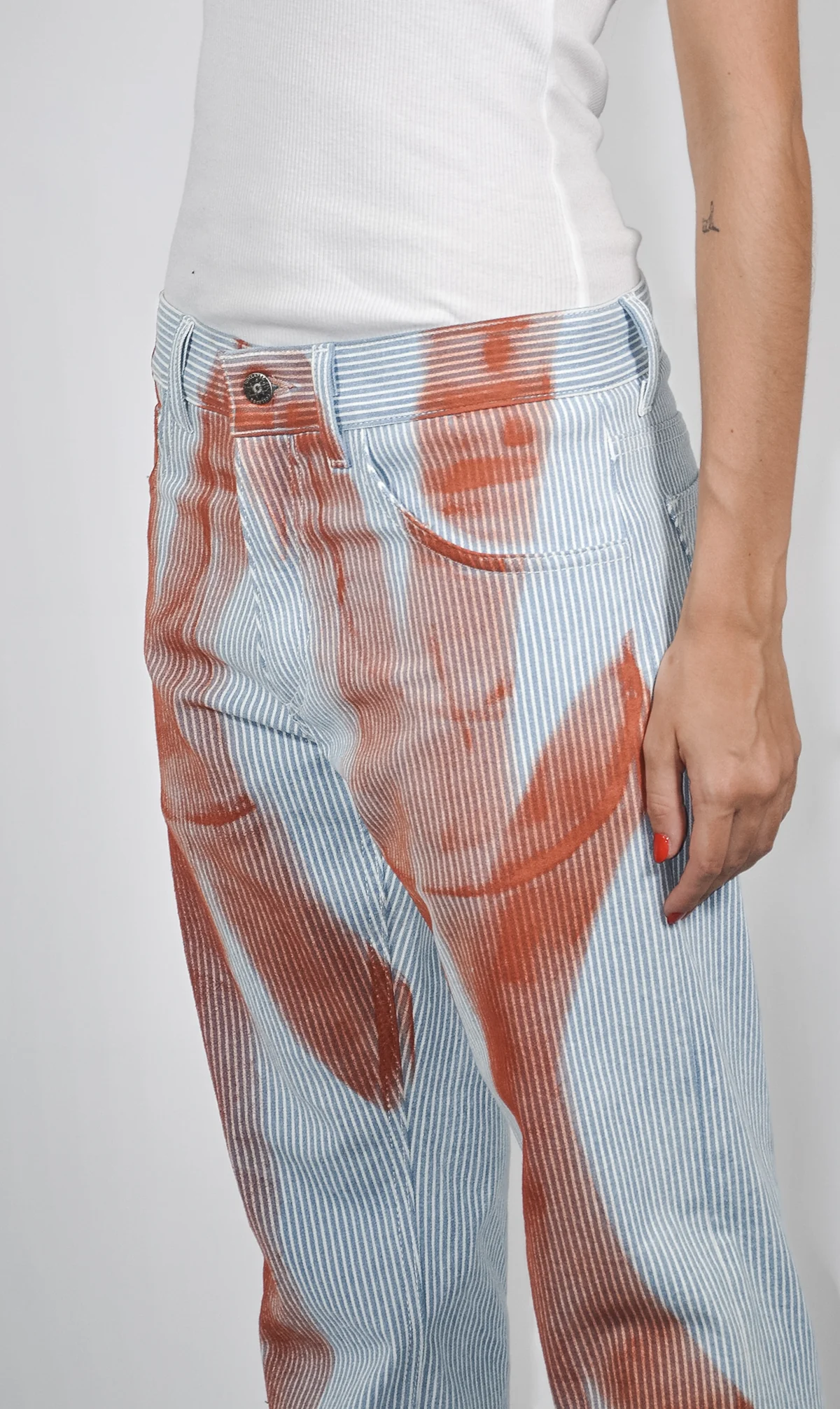Striped trousers with red Fe26 applications
