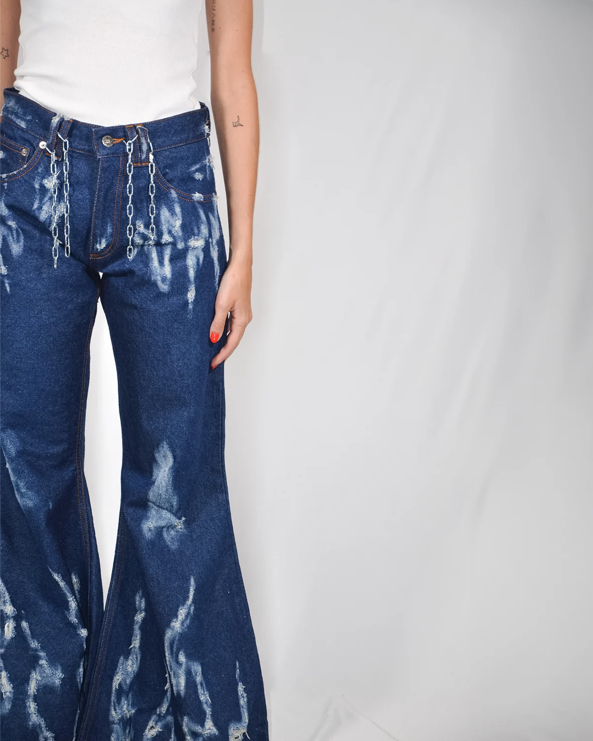 Front view of Fe26 trousers with graphic marks and a flared silhouette