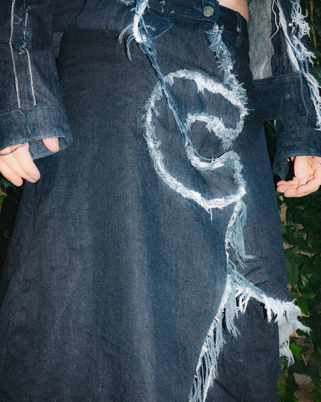 Denim skirt detail with COLLAPSE motif