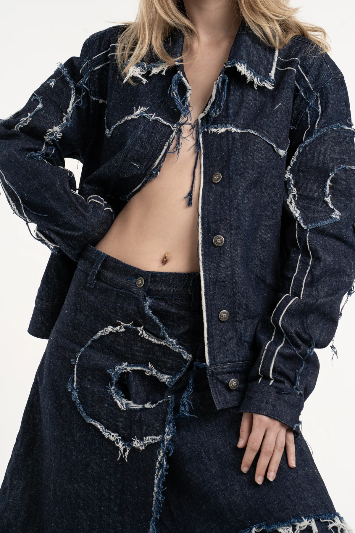 Denim jacket detail with stitching and graphic marks