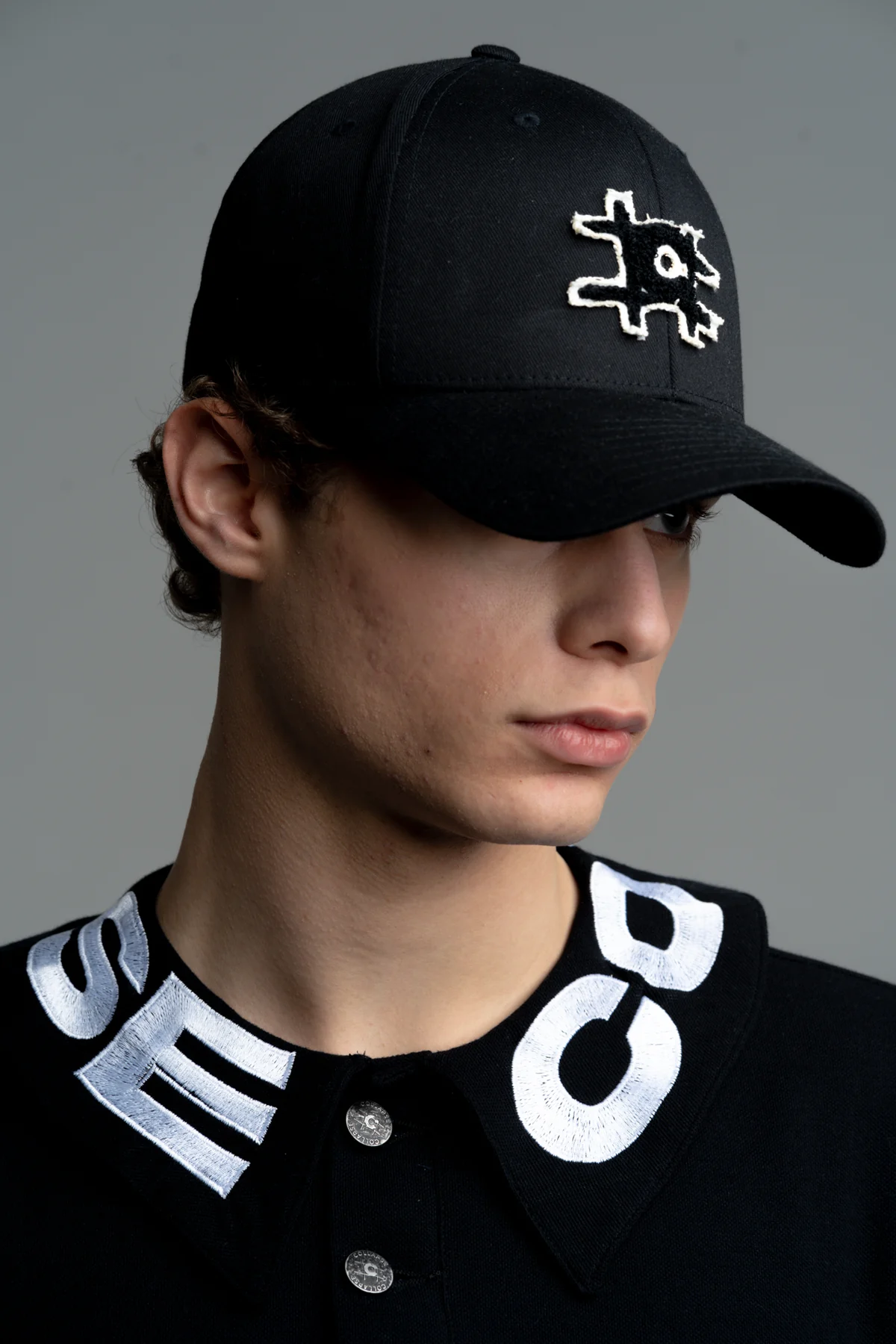 Black cap and collar with COLLAPSE lettering