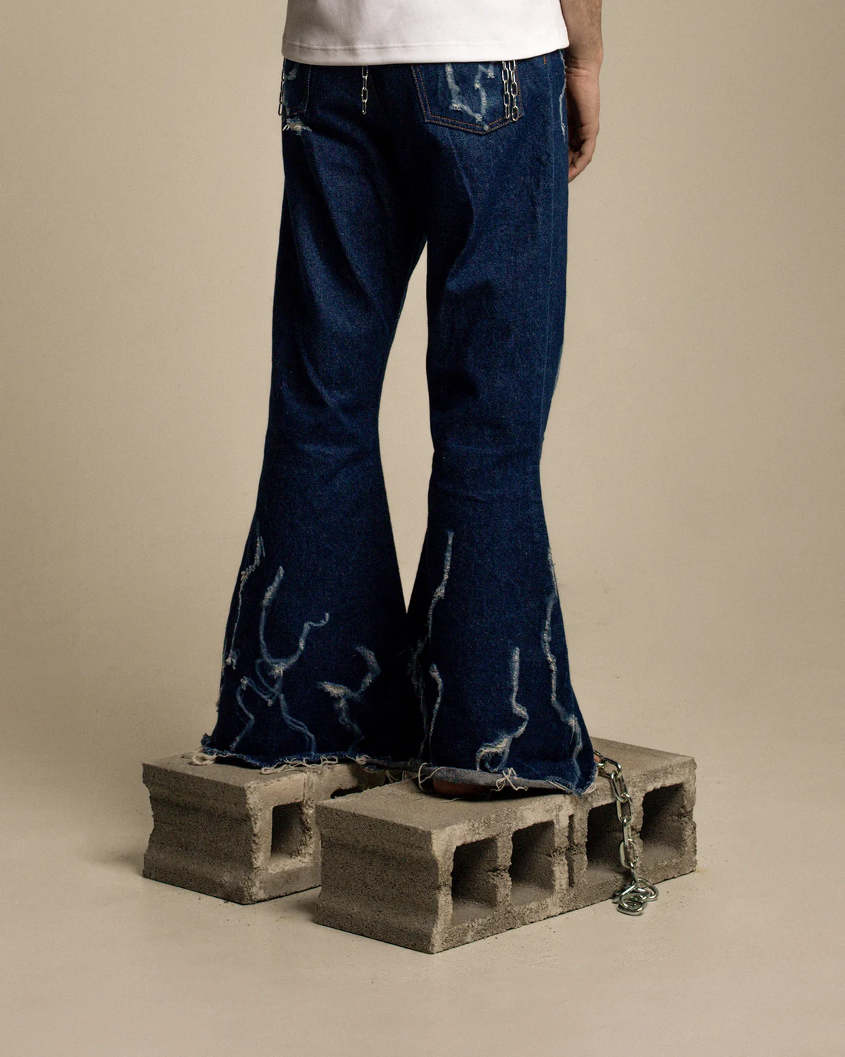 Flared denim trousers with light graphic marks