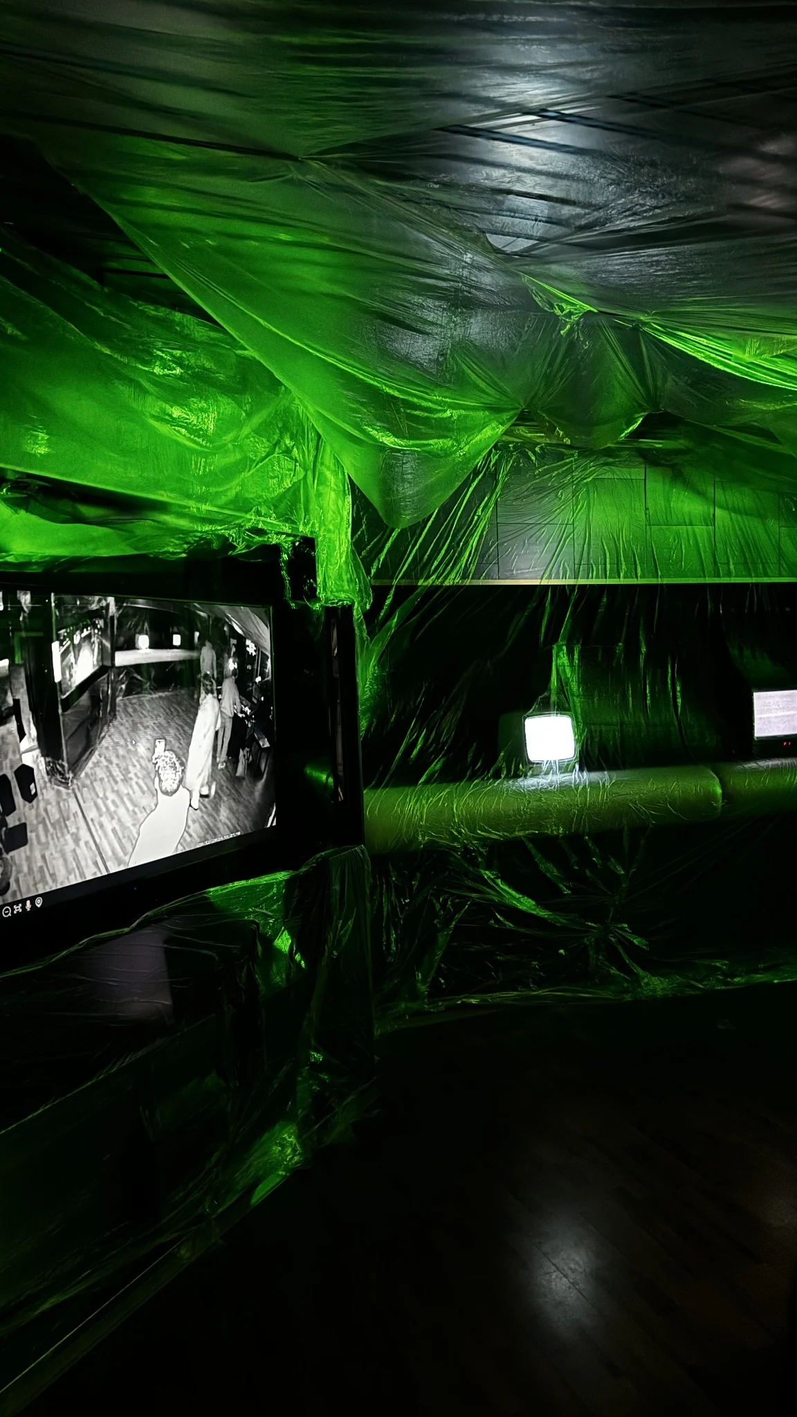 Room setup with draped fabric and green lighting
