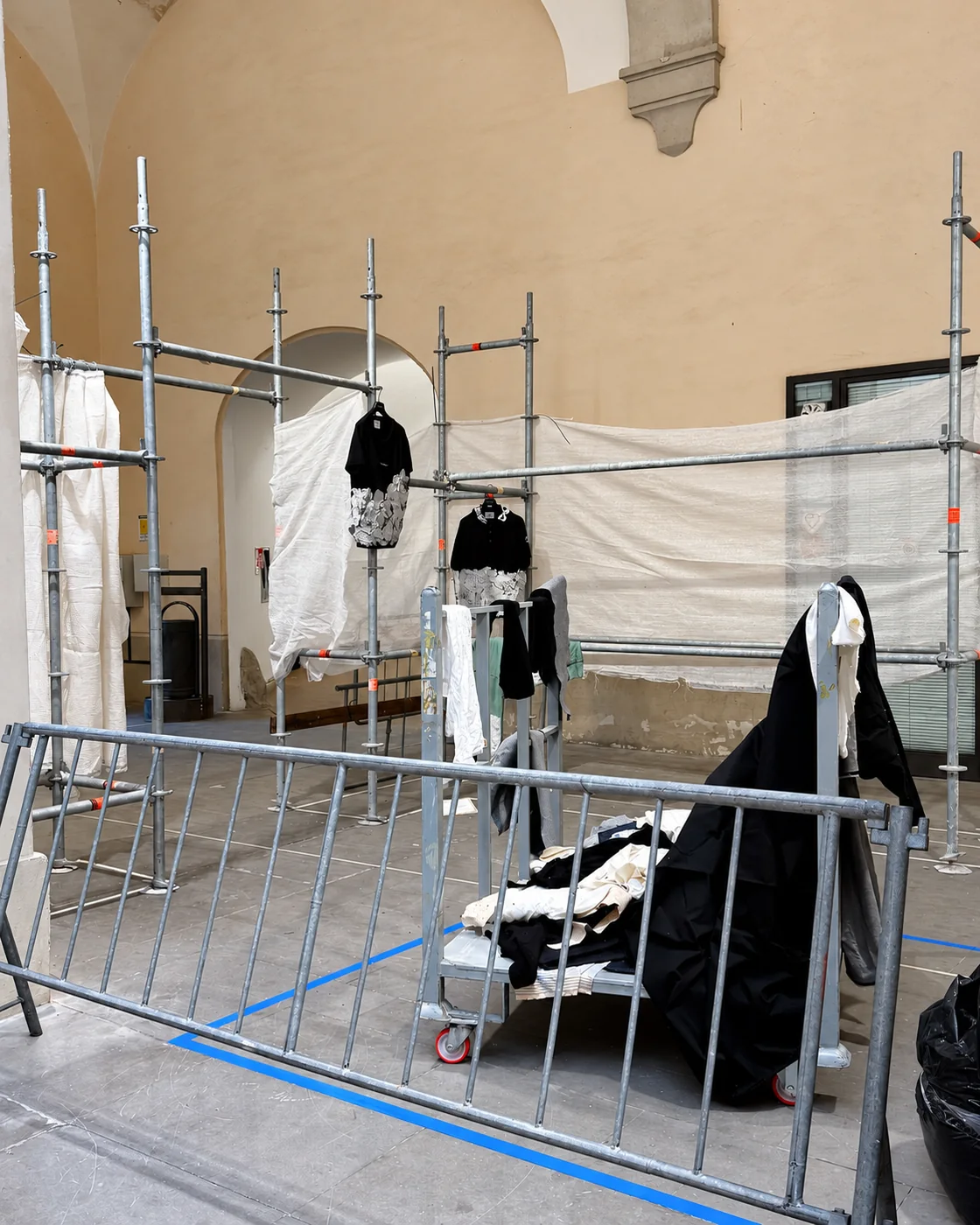 COLLAPSE garments installed on scaffolding structures with fabric partitions