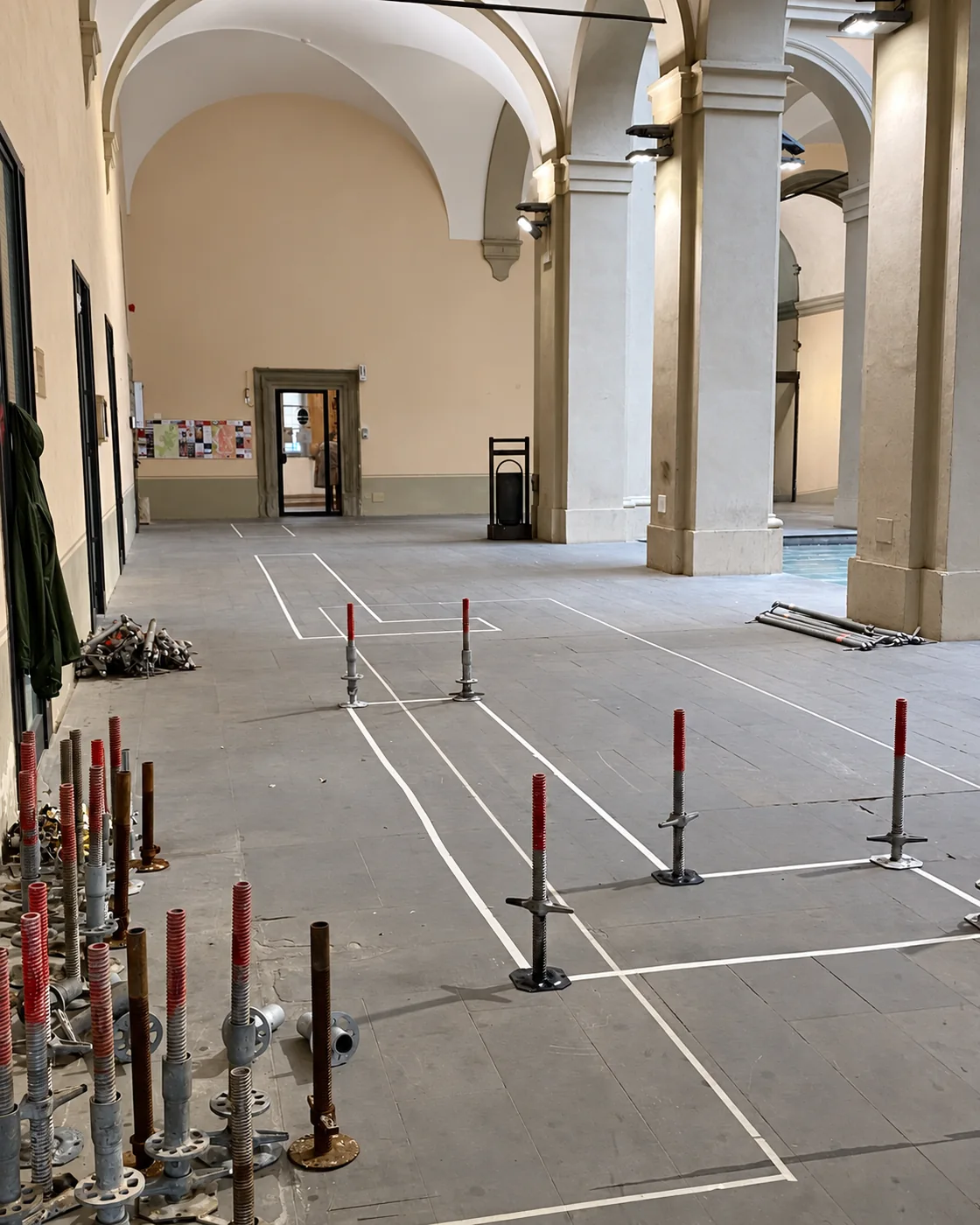 Floor markings and exhibition structure bases inside the Loggiato